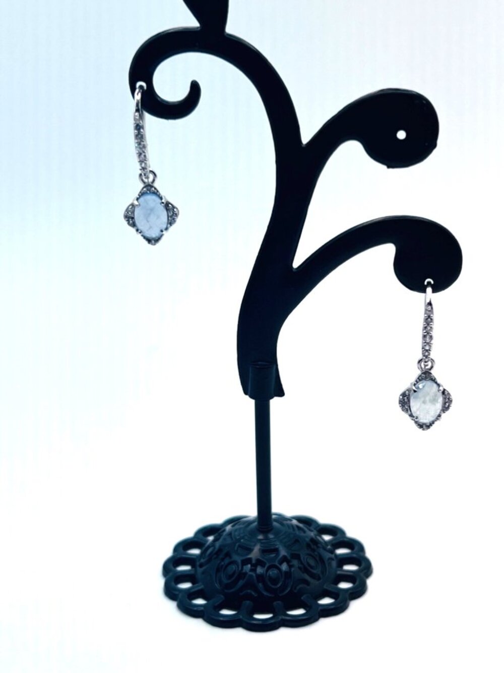 Earrings with light blue stones encircled with CZ type stones